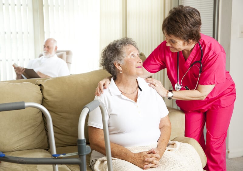 Senior woman in a nursing home, with a caring nurse