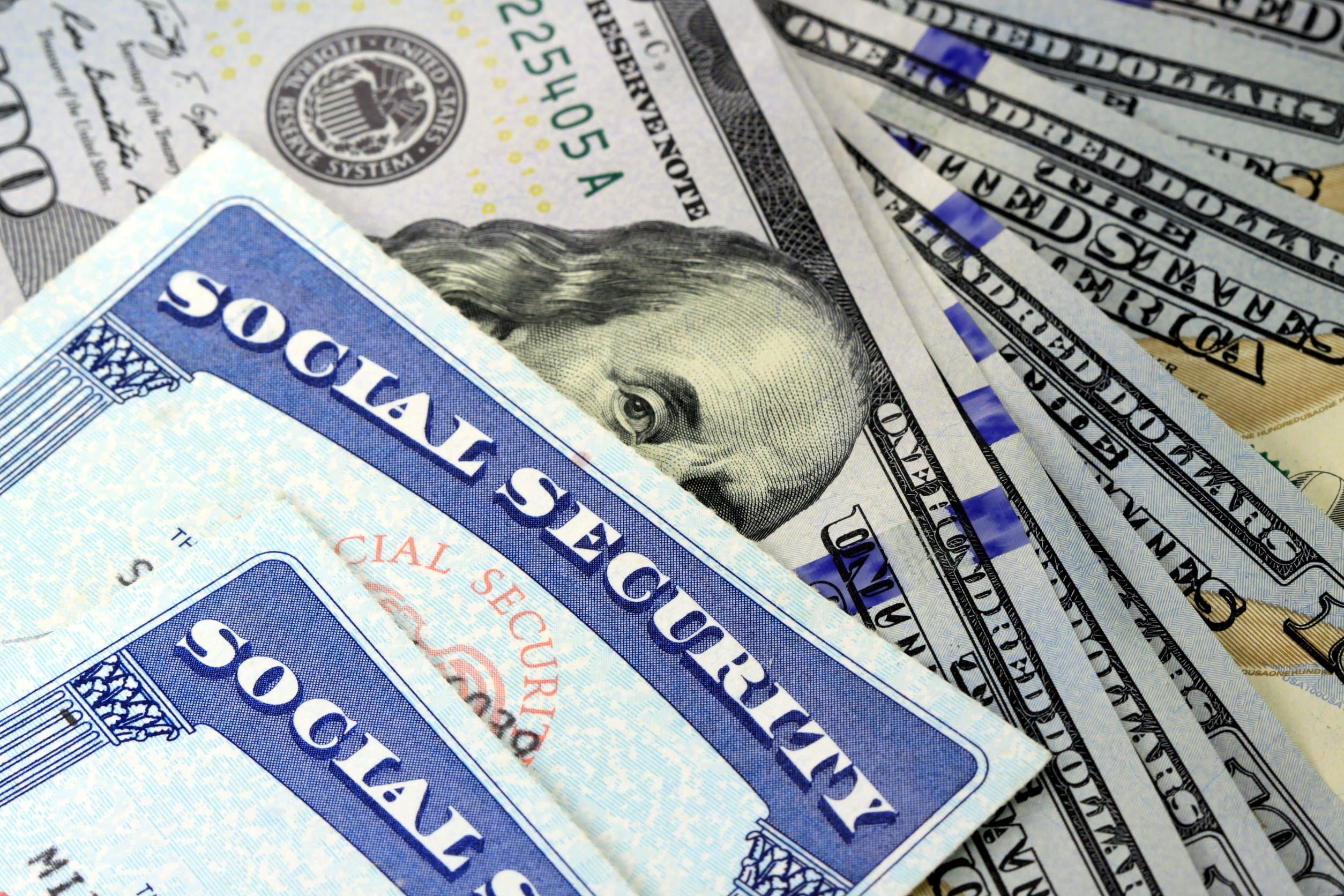 Social Security card and US currency (one hundred dollar bills)